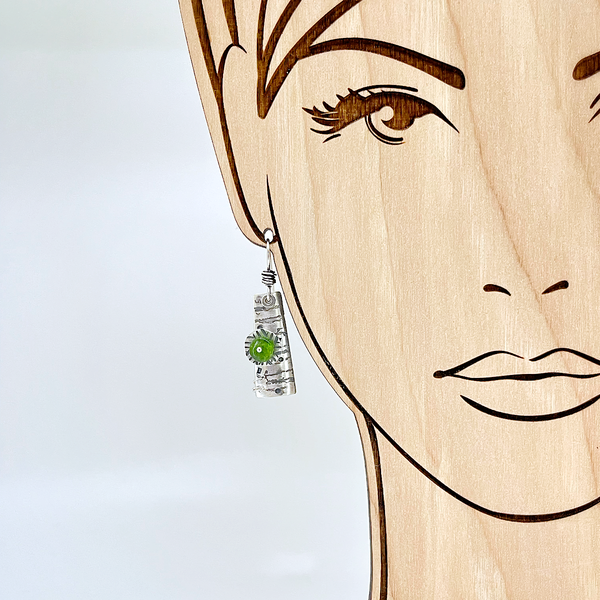 Sterling silver earrings with chrome diopside by Kristin Christopher - view on model