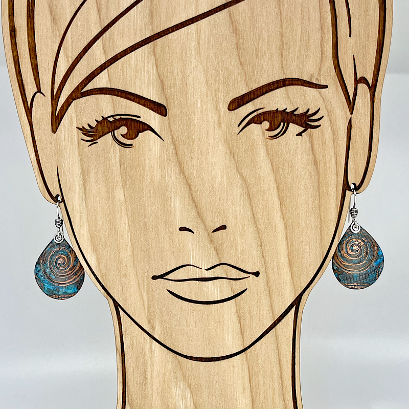 Teardrop blue copper patina earrings shown on model