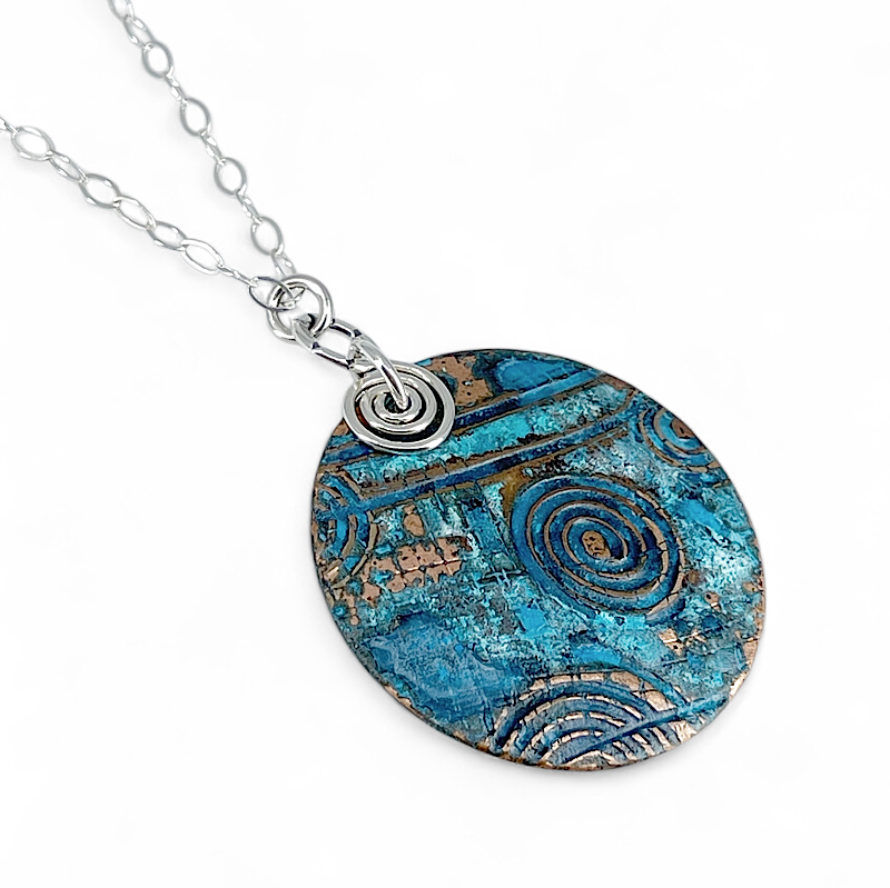 Pendant of copper blue patina with spirals