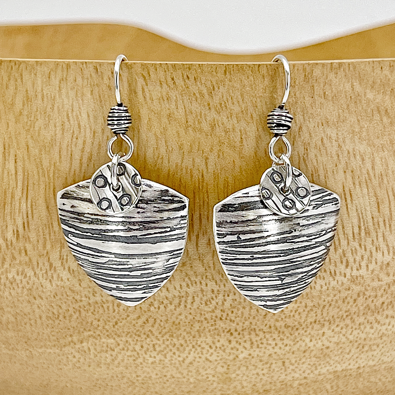 Textural sterling silver triangular earrings front view