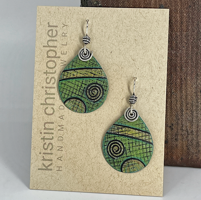 Green teardrop earrings with spiral patterns on a 'Kristin Christopher Handmade Jewelry' card.