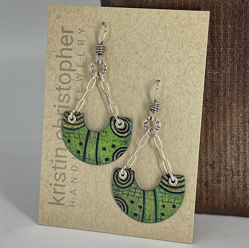 Green and silver earrings on a 'Kristin Christopher' handmade jewelry card.