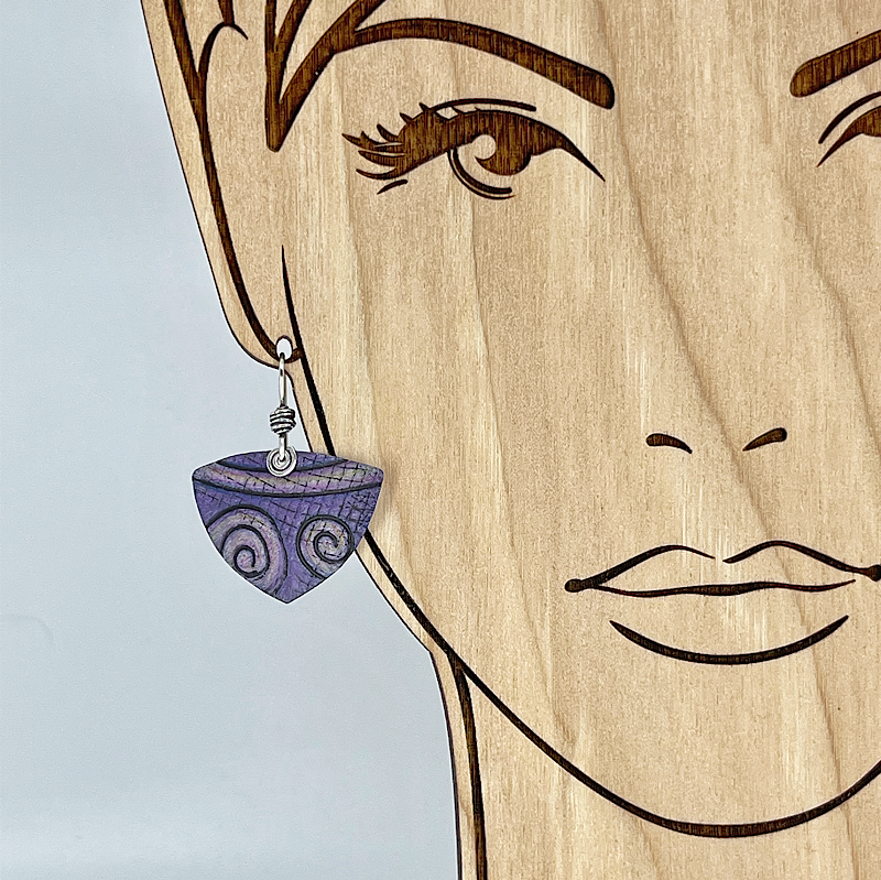 Purple spiral earring shown on model