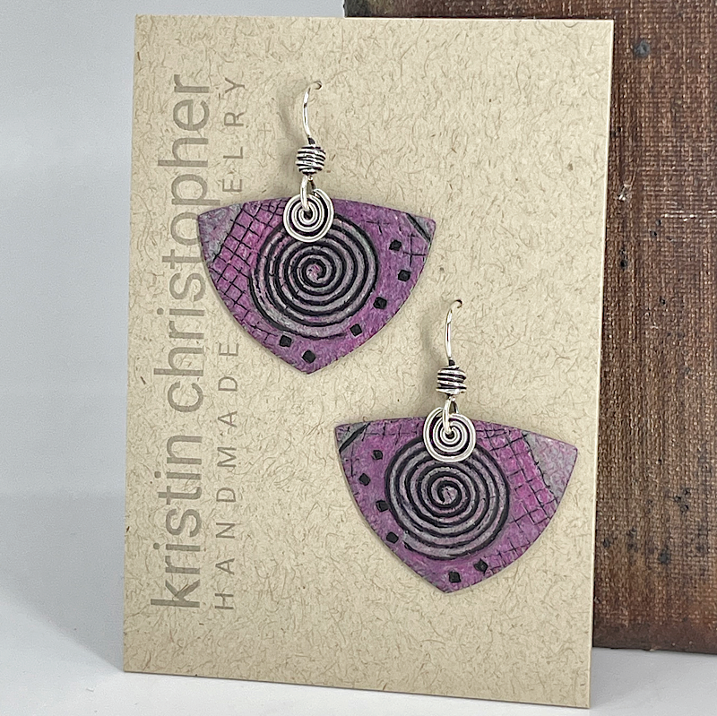 Pink spiral pattern earrings with silver spirals on a 'Kristin Christopher' card