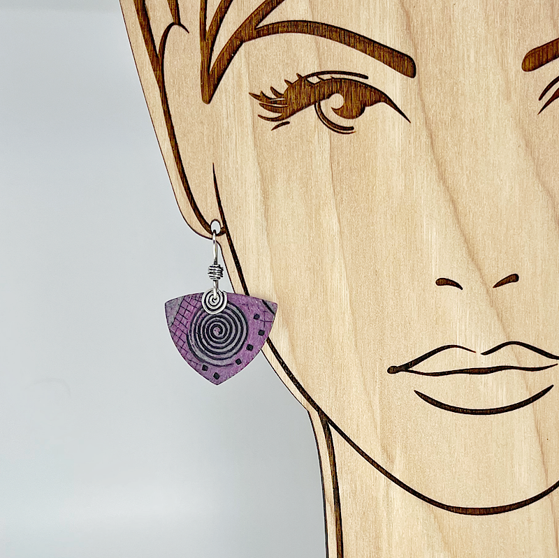 Pink earring with sterling silver spirals shown on model