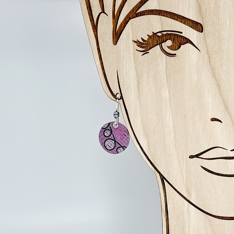 Pink patterned earring shown on a model