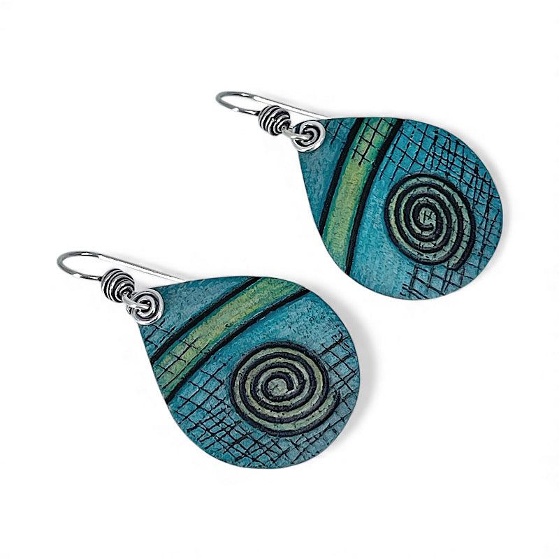 Teal and green spiral patterned earrings on a white background
