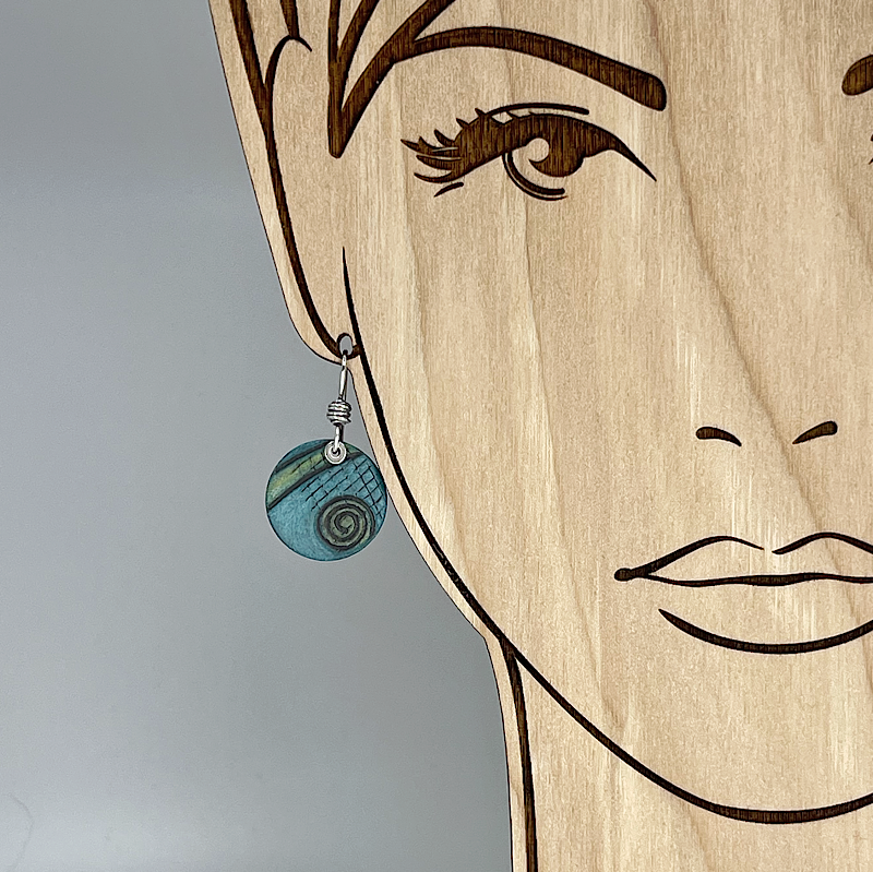 Aqua earring with spiral design shown on model