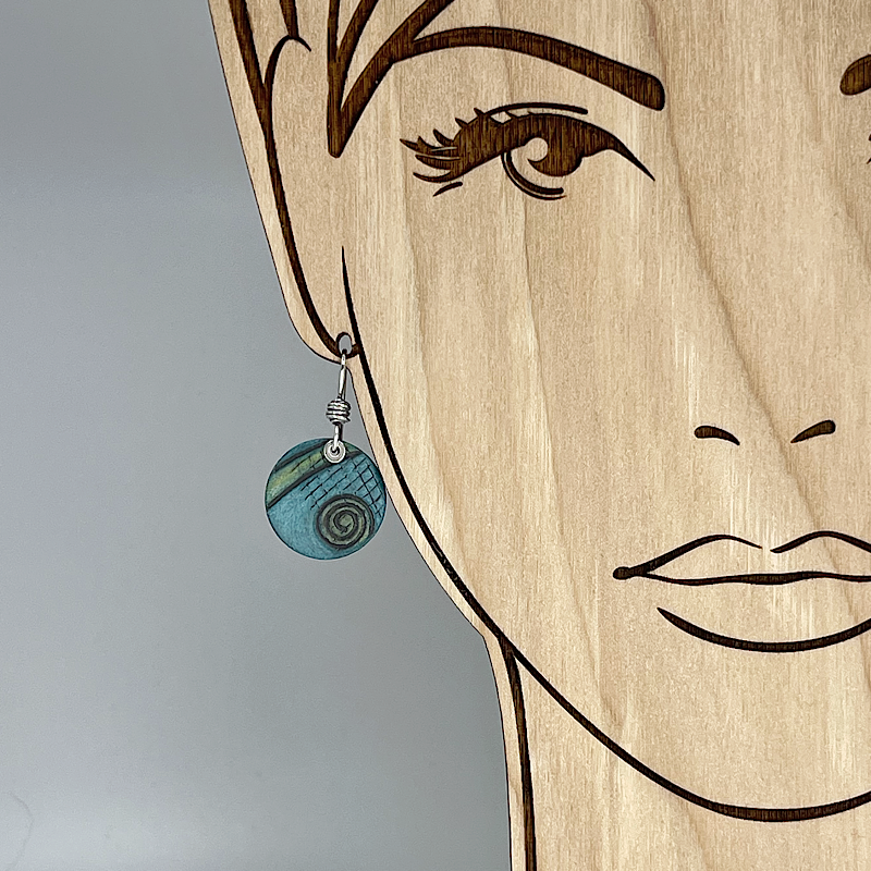 Aqua earring with spiral design shown on model