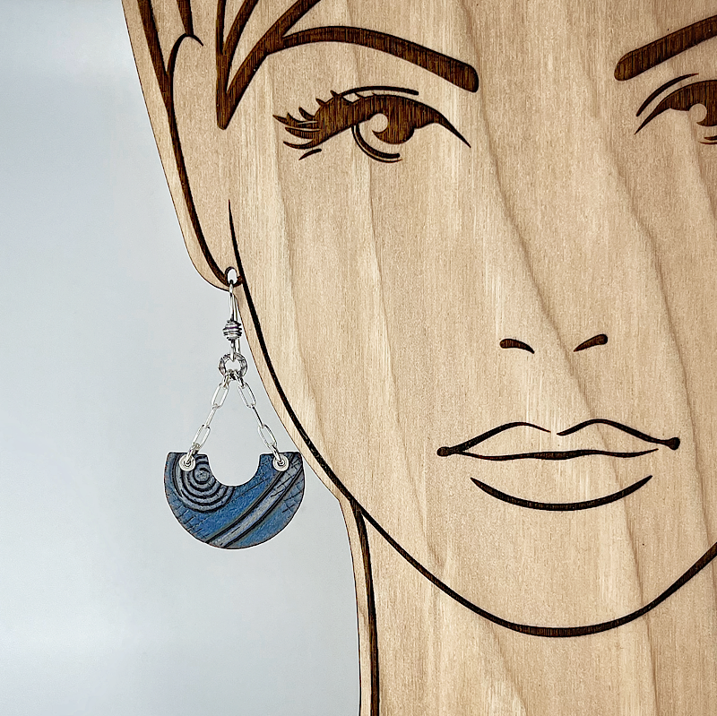 Blue and silver earring shown on model