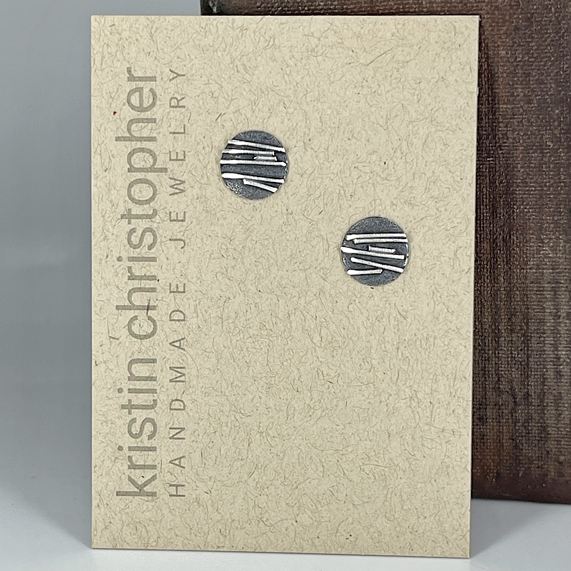 Pair of post silver earrings on a 'Kristin Christopher' branded card.
