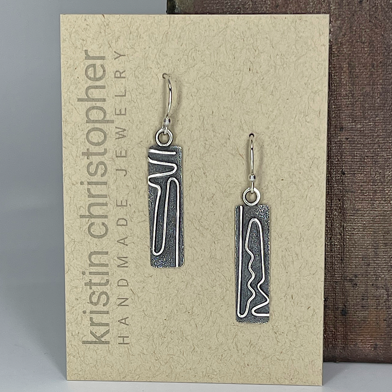 Sterling silver mod earrings on a 'Kristin Christopher Handmade Jewelry' card.