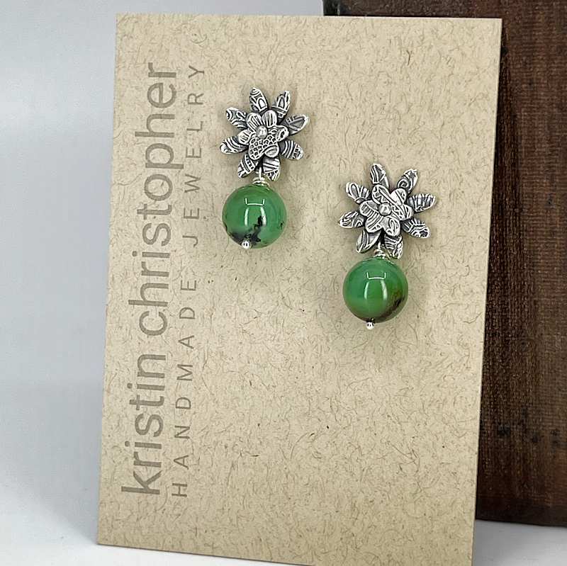 Sterling silver floral post earrings with chrysoprase green beads on a 'Kristin Christopher' card.