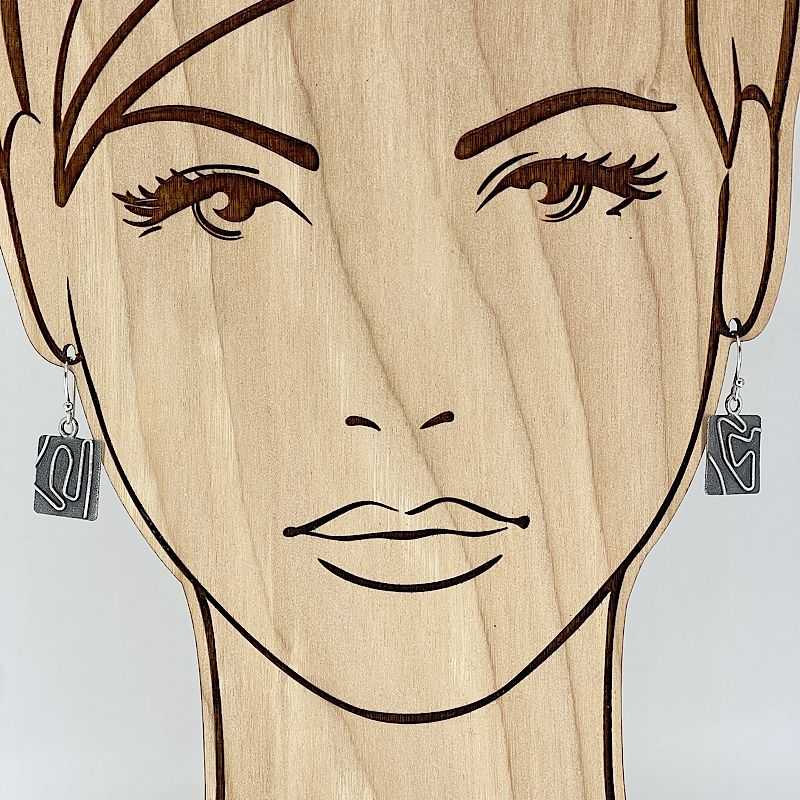 Unique sterling silver earrings on a model