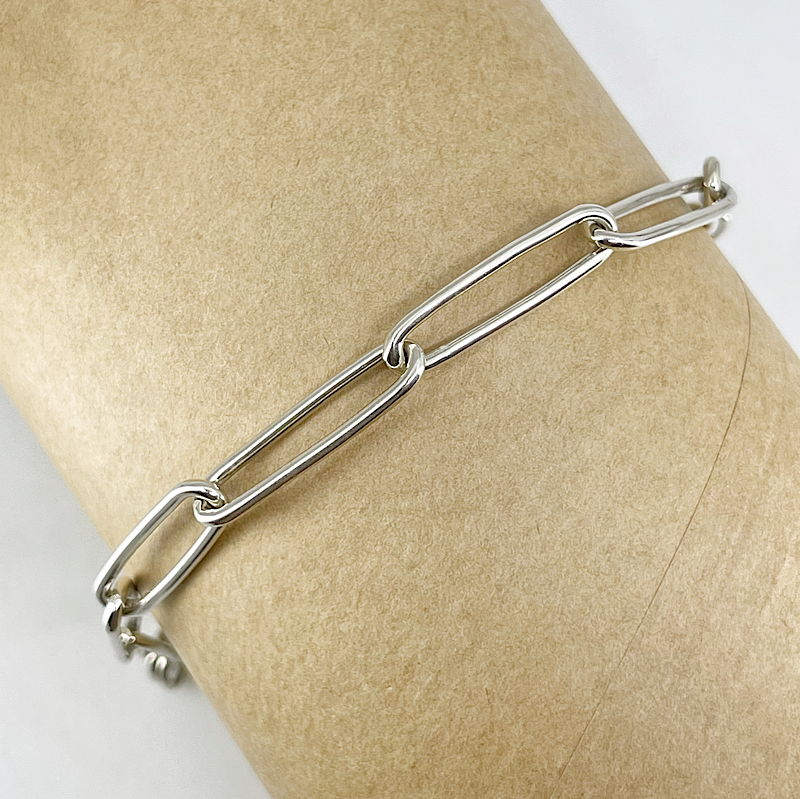 Sterling silver paperclip chain bracelet shown on a mannequin wrist