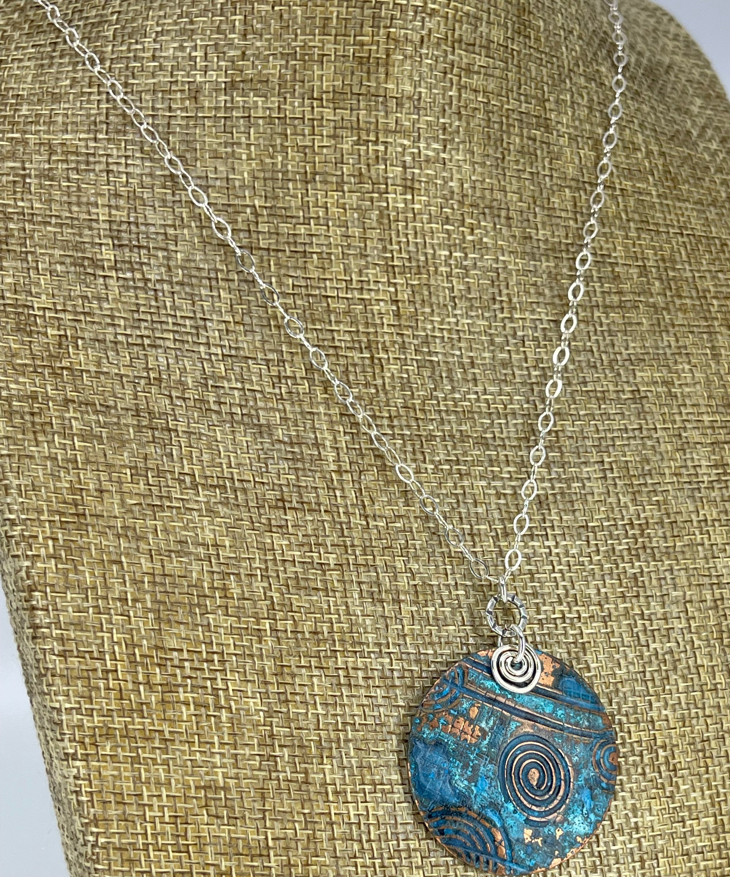 Copper blue patina necklace shown on linen display bust
