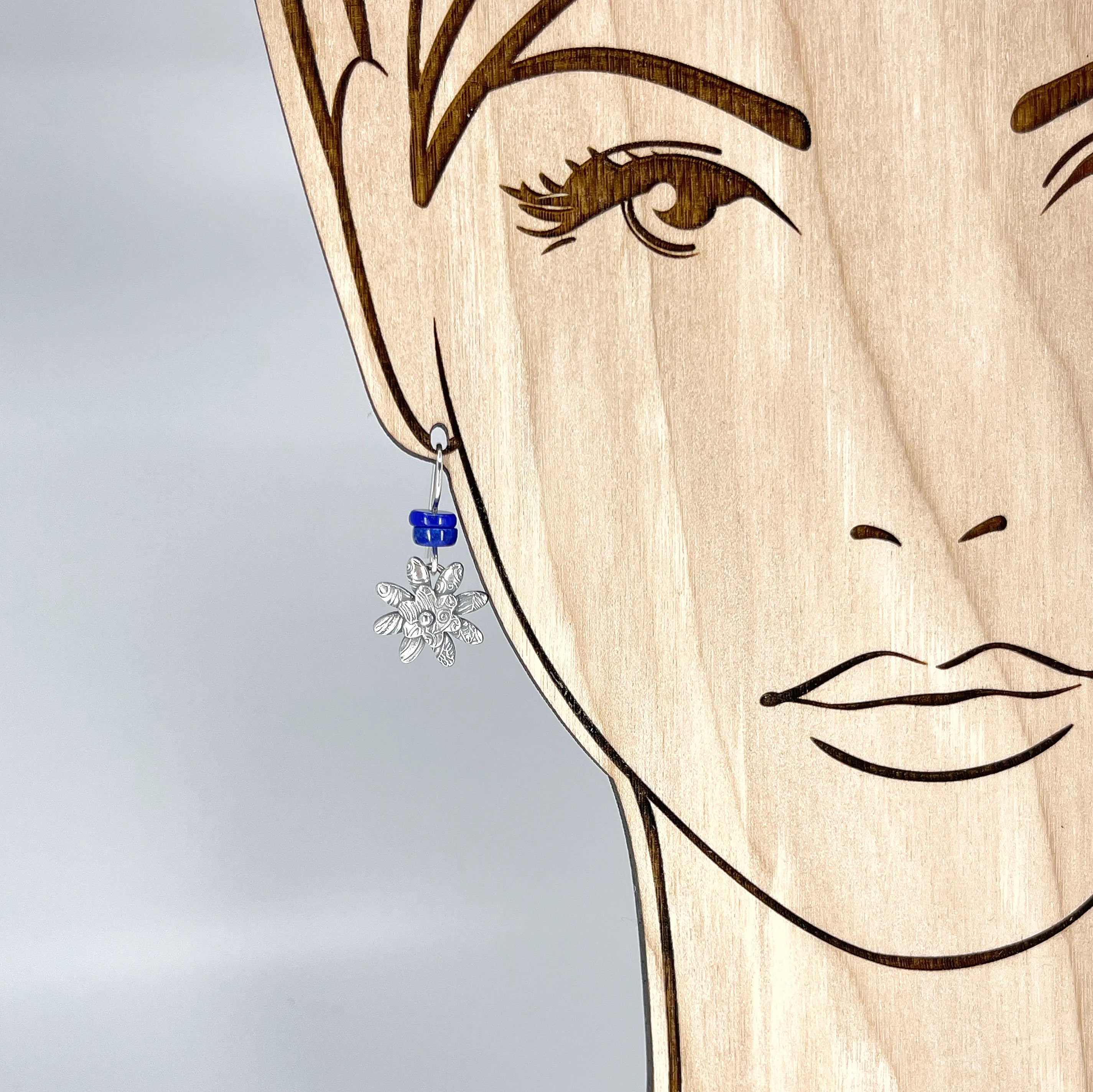 Sterling flower earrings with Lapis by Kristin Christopher - view on model