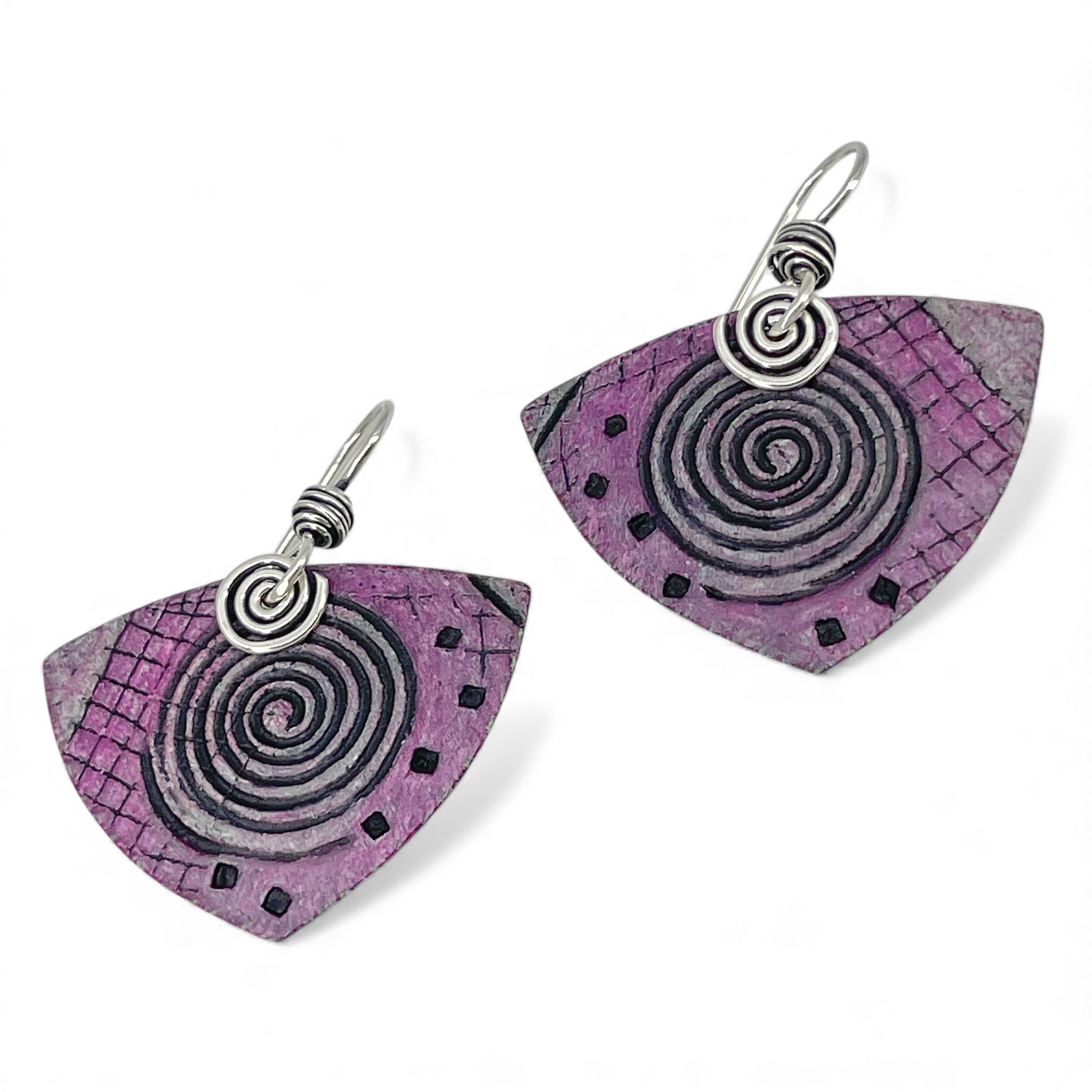 Pair of pink earrings with spiral design on a white background