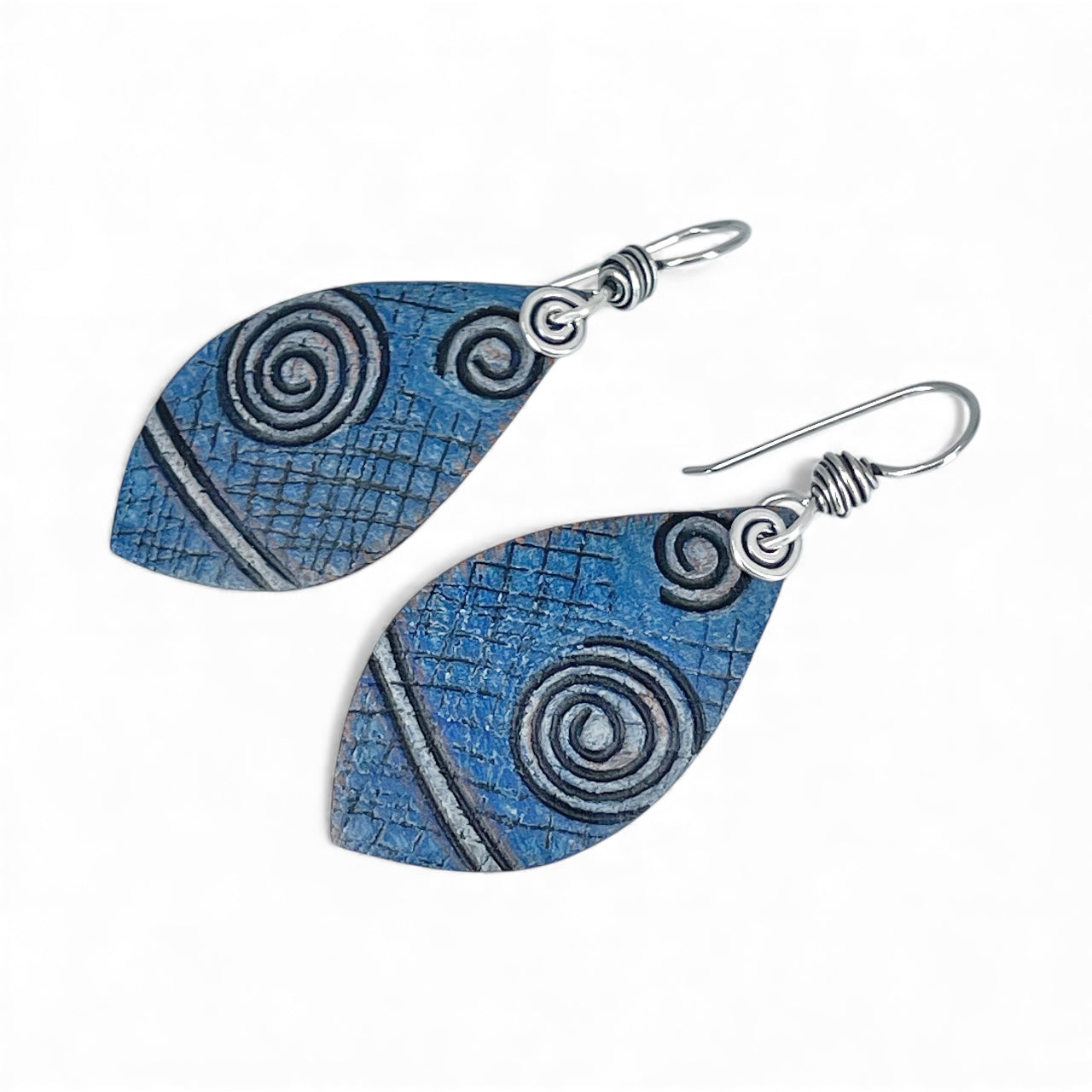Pair of blue spiral patterned earrings on a white background