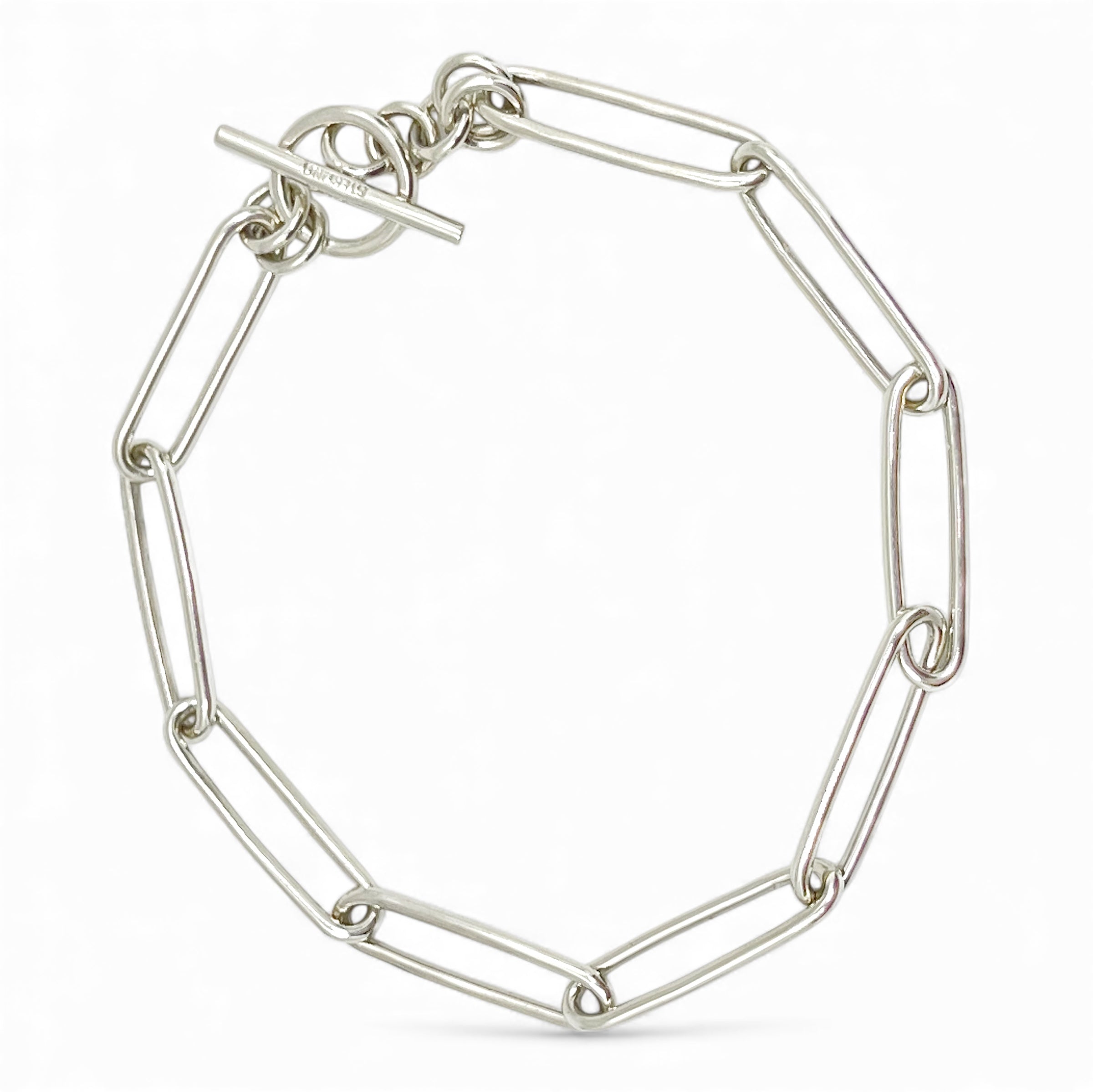 Sterling silver paper clip chain bracelet on white background