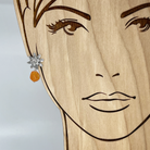 Sterling Silver Flower Earring with orange gemstone shown on model