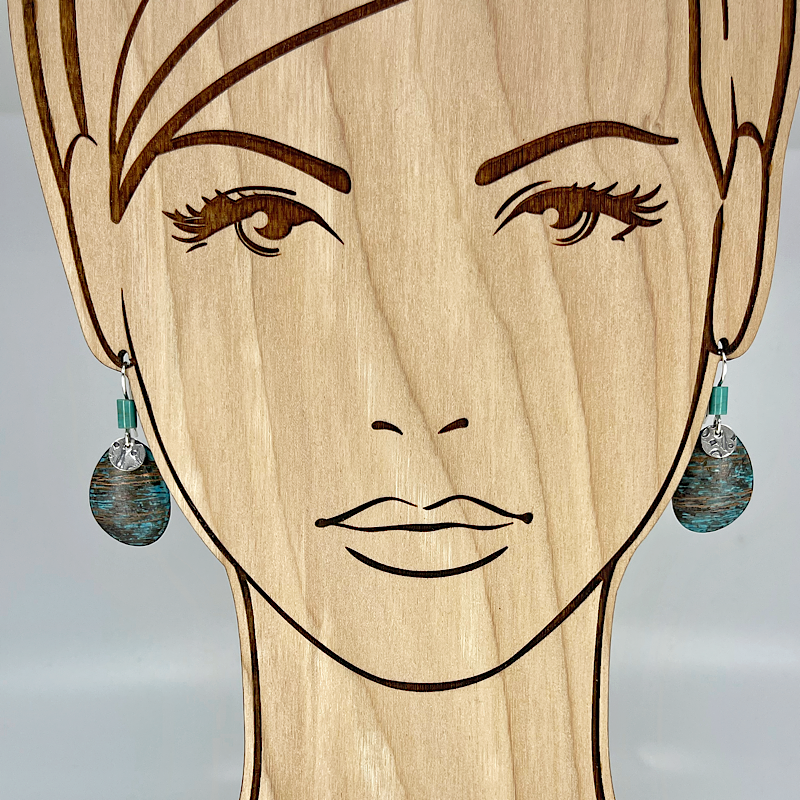Blue copper patina earrings with turquoise shown on model