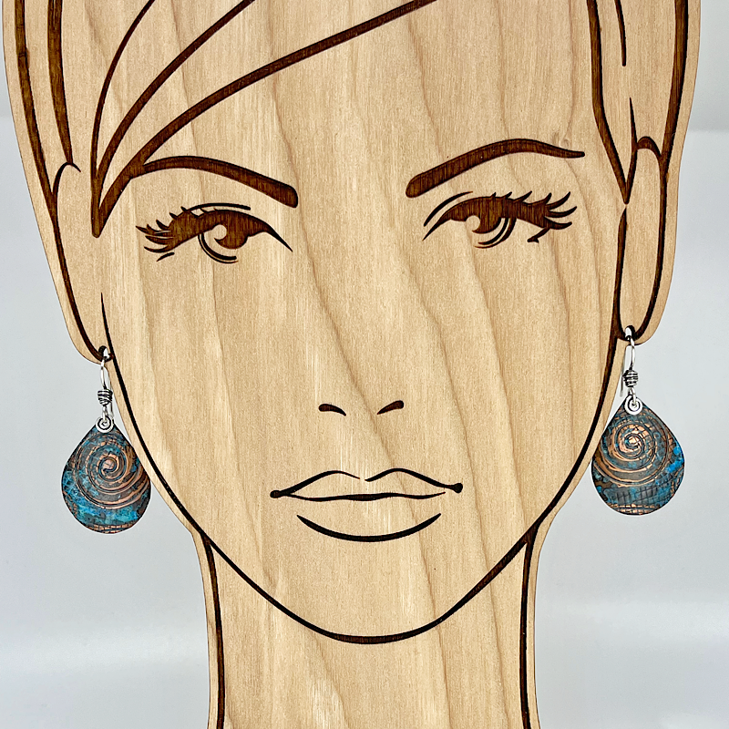 Teardrop blue copper patina earrings shown on model
