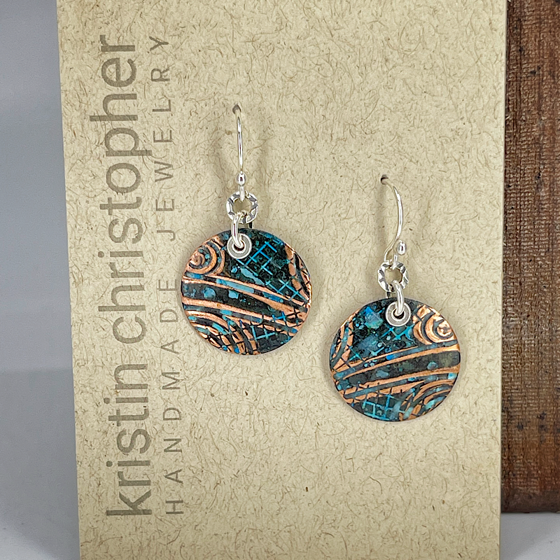 Copper earrings with circle shape shown on card