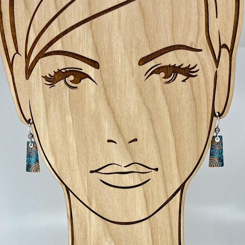 Rectangular copper blue patina earrings shown on model