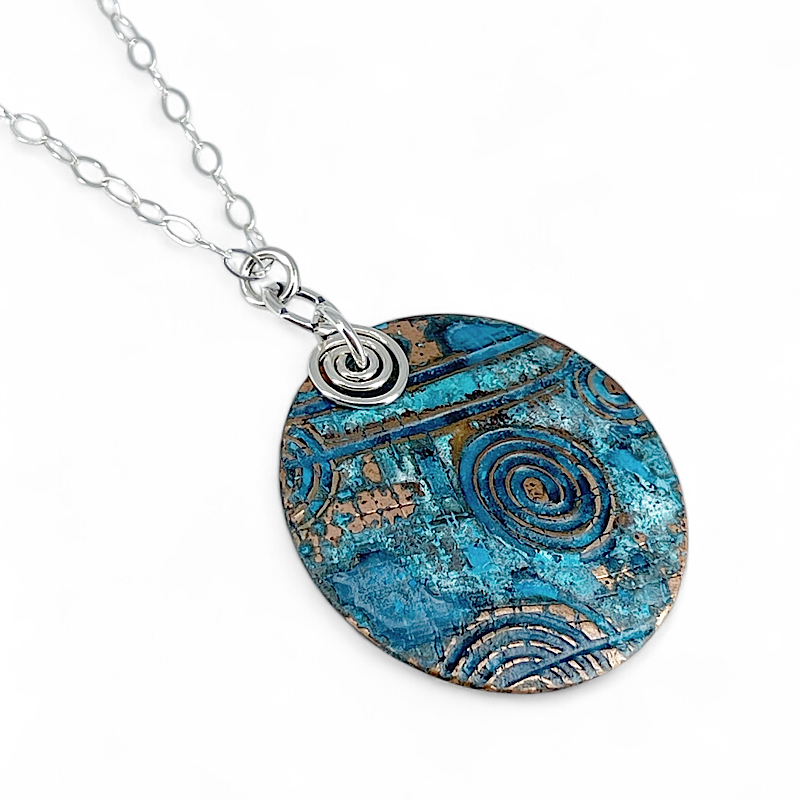 Pendant of copper blue patina with spirals