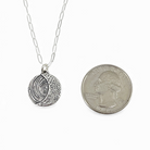 Crescent moon pendant is smaller than a quarter.