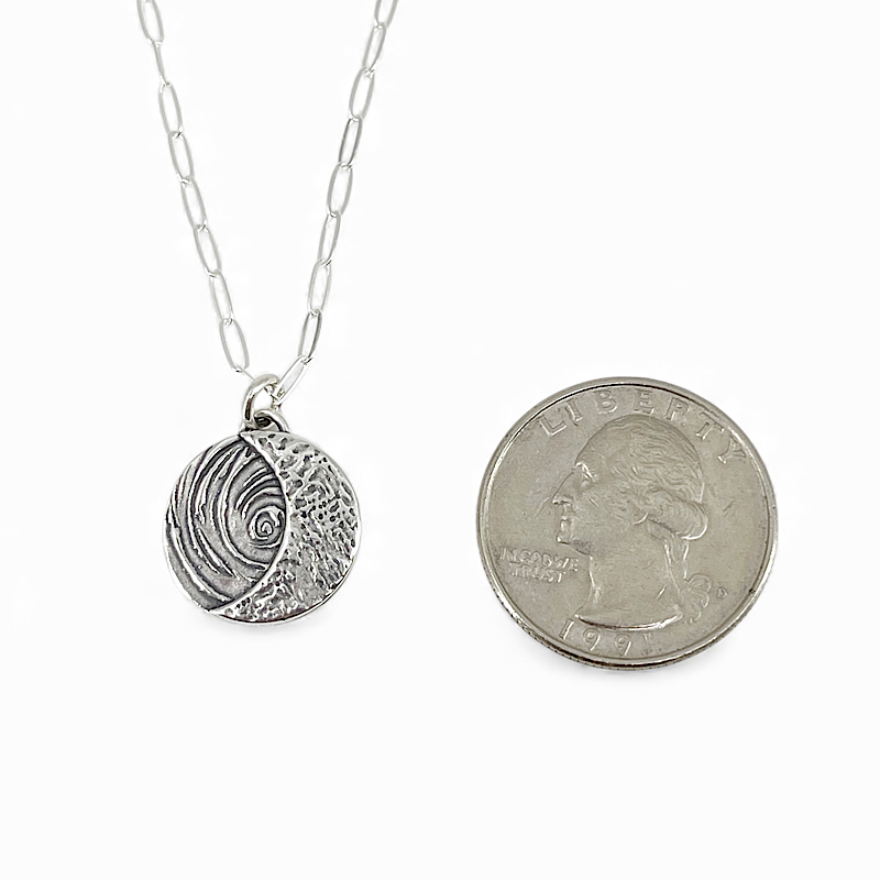 Crescent moon pendant is smaller than a quarter.