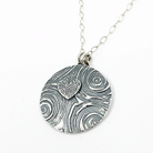 sterling silver heart necklace with spiral patterns