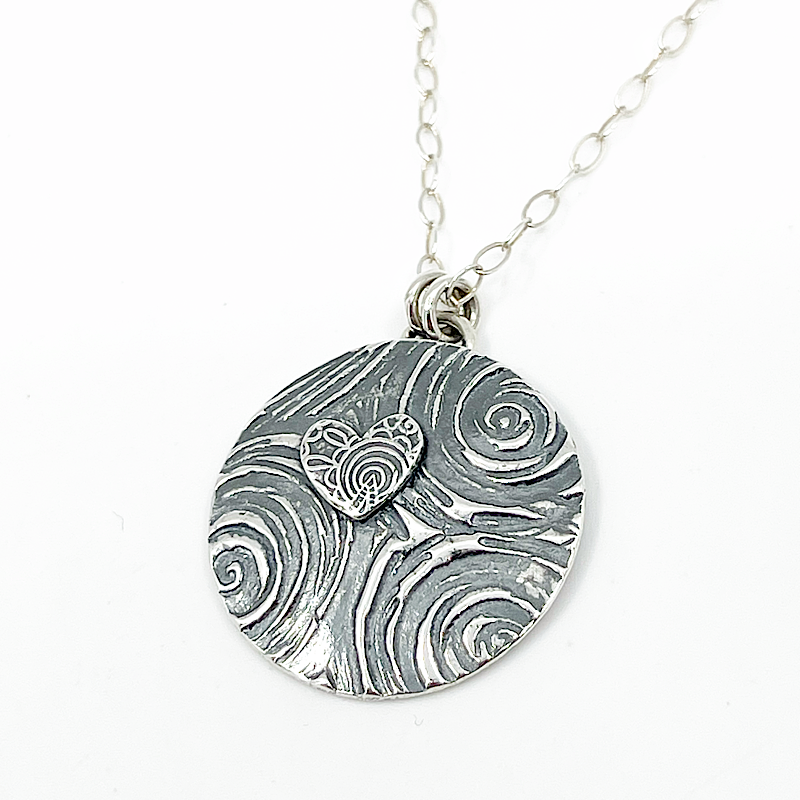 sterling silver heart necklace with spiral patterns