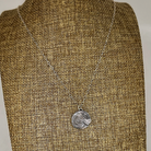 Silver heart necklace on a linen bust