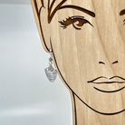 Triangle silver earring shown on model