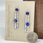 Silver earrings with blue lapis beads on a 'Kristin Christopher' jewelry card.