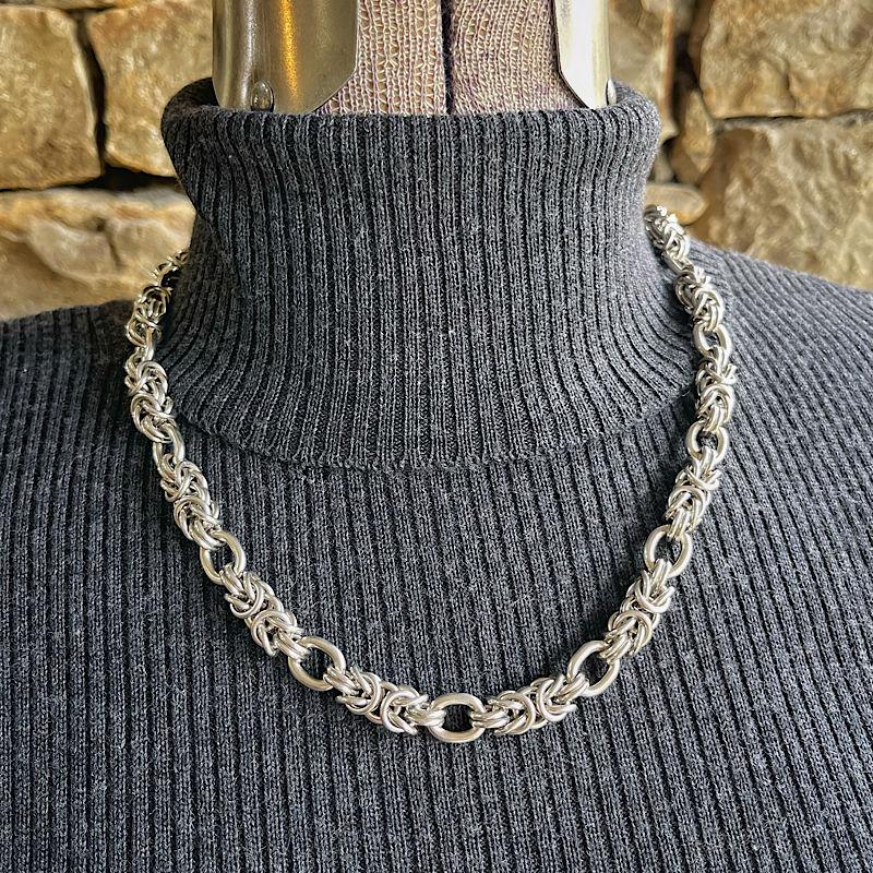 Silver byzantine chainmail necklace on a mannequin.