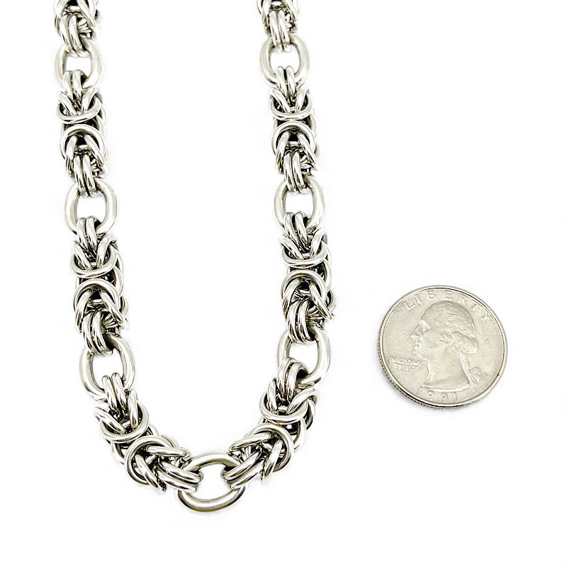 Heavy-weight sterling silver byzantine chain next to a quarter to show scale
