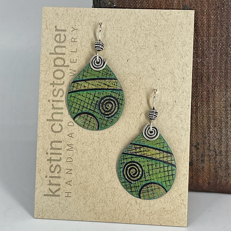 Green teardrop earrings with spiral patterns on a 'Kristin Christopher Handmade Jewelry' card.