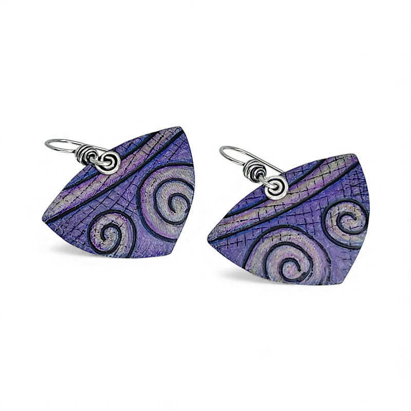 Pair of purple spiral patterned earrings on a white background