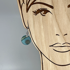 Aqua earring with spiral design shown on model