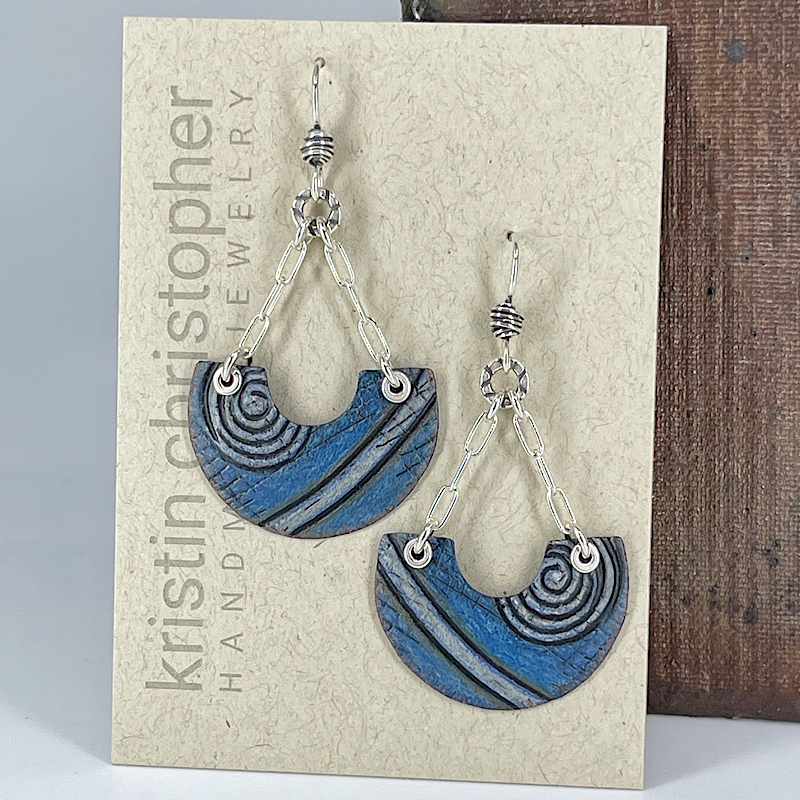 Blue and silver earrings on a Kristin Christopher branded card