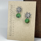 Sterling silver floral post earrings with chrysoprase green beads on a 'Kristin Christopher' card.