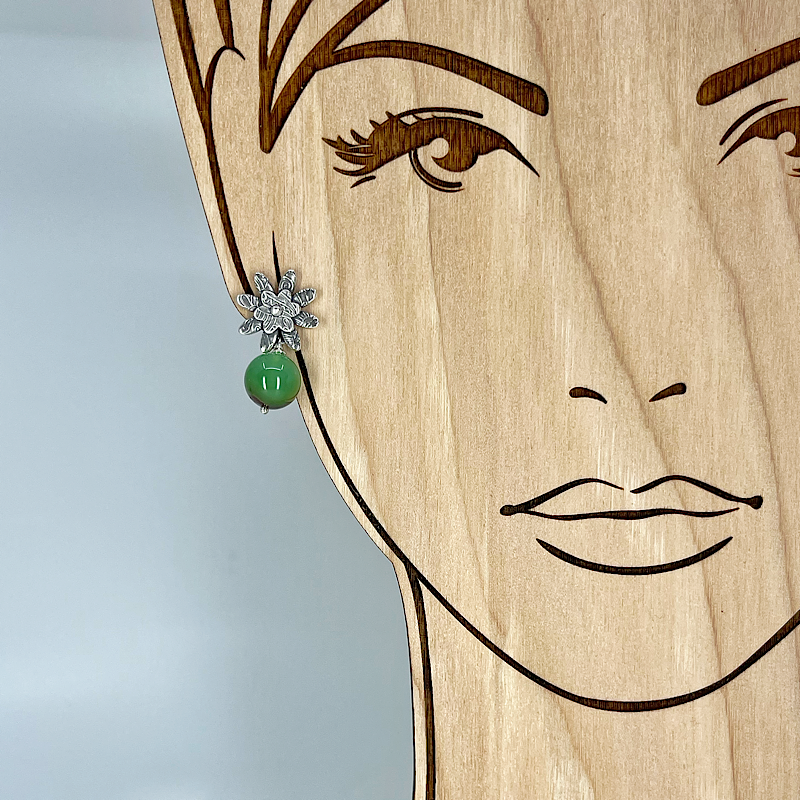 Sterling silver post flower earrings with a chrysoprase bead shown on a model