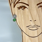 Sterling silver post flower earrings with a chrysoprase bead shown on a model