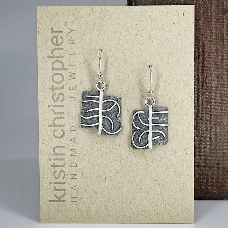 Unique sterling silver earrings on a 'Kristin Christopher Handmade Jewelry' card.