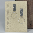 Sterling silver earrings with silver hoops on a 'Kristin Christopher Handmade Jewelry' card.