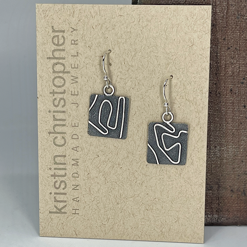 Unique sterling silver earrings with a modern art pattern on a 'Kristin Christopher' card