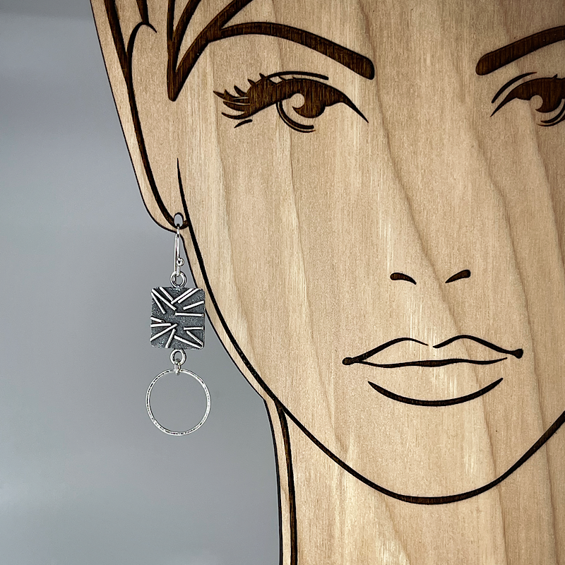 Unique sterling silver earring with hoop shown on model for scale